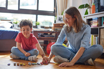 Loving moment of happy mother playing with her children.