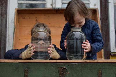 Close-up of boy water jars