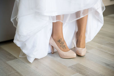 Low section of bride with tattoo on leg