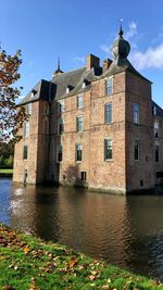 Church by water against sky