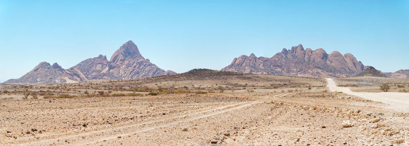 Scenic view of rocky mountains against clear blue sky