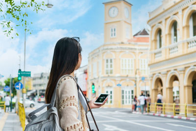 Asian traveler woman walking on phuket thailand old town. travel concept