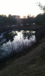 Scenic view of river at sunset