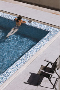 High angle view of woman swimming in pool