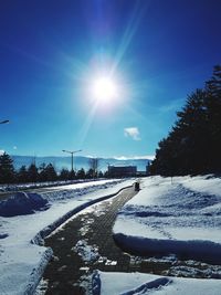 Snow covered road against sky