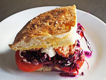 High angle view of burger slice in plate on table