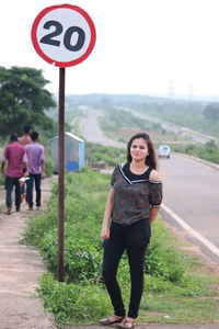 Low section of woman standing on road