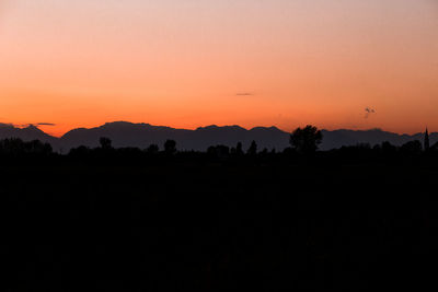 Scenic view of silhouette landscape against romantic sky at sunset