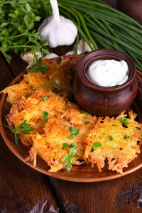 Potato fritters  a pancake, especially one made with grated potato served with sour cream.