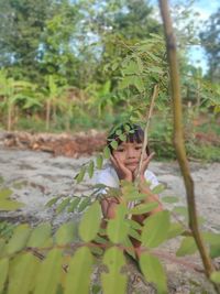 Portrait of girl on plant