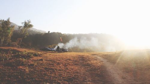 Silhouette of woman standing on landscape