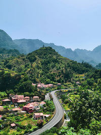 High angle view of road amidst trees against sky