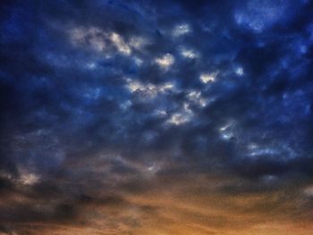 Low angle view of cloudy sky at sunset