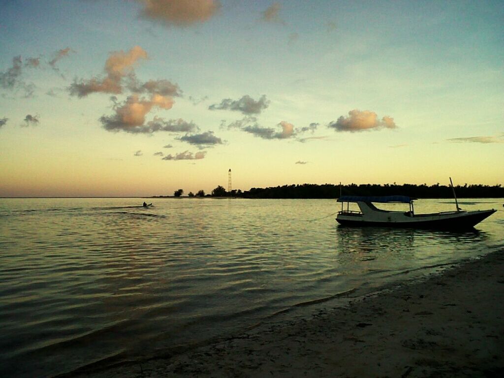 BOATS MOORED IN SEA AGAINST SKY