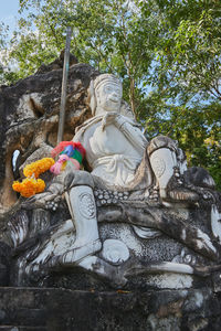 Low angle view of statue against trees