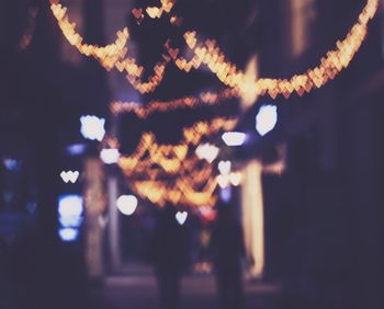 Defocused image of illuminated city street at night