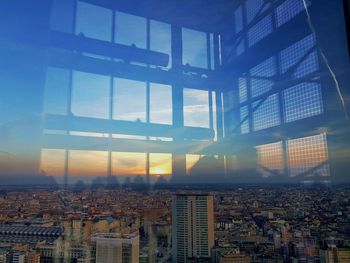 Illuminated cityscape against sky