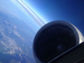 Airplane flying over sea against sky