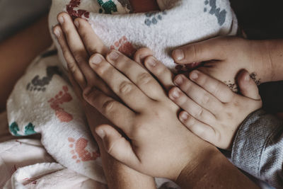 Midsection of woman with baby hands