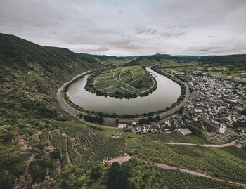 High angle view of land against sky with a river bend