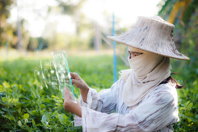 Side view of young woman on field