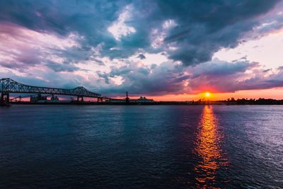 View of bridge over sea against cloudy sky