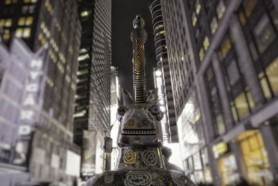 Low angle view of statue against temple