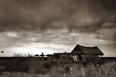 Buildings against cloudy sky