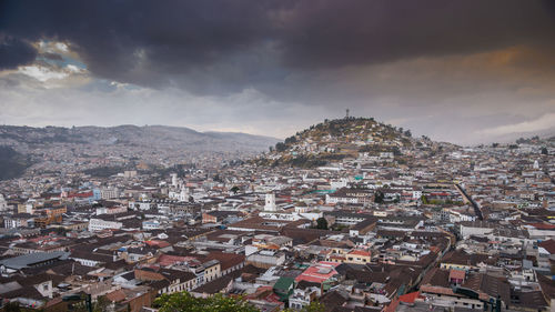 Cityscape against cloudy sky