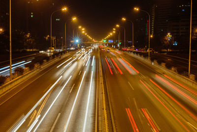 High angle view of light trails on multiple lane highway at night