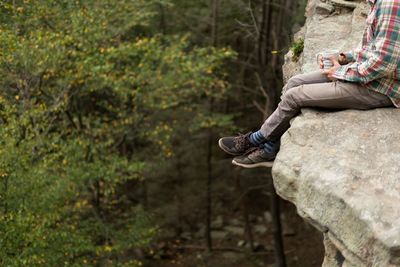 Low section of man sitting outdoors