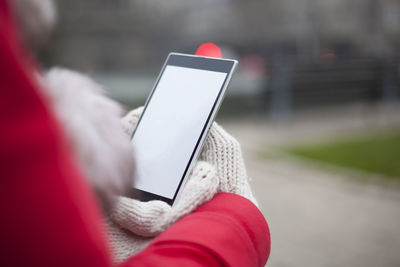 Close-up of woman holding mobile phone