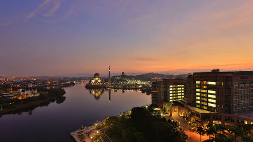 High angle view of illuminated buildings against sky during sunset