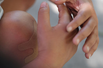 Midsection of boy with bandage on knee