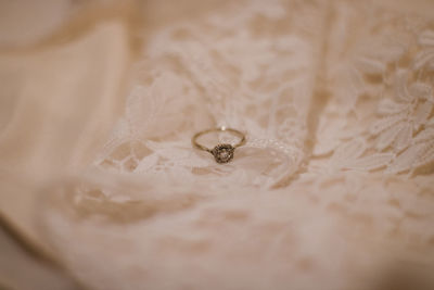 High angle view of wedding ring on fabric