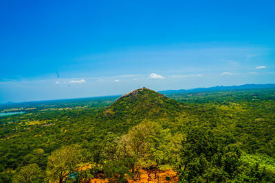 Scenic view of landscape against blue sky