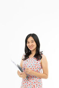 Portrait of a smiling young woman against white background