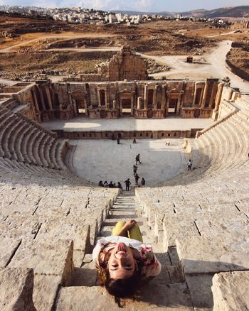 Woman sitting at old ruin