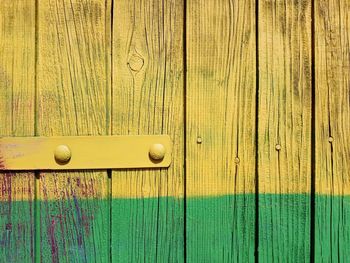 Full frame shot of yellow and green colored wood paneling