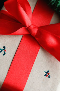 Close-up of christmas present with red ribbon