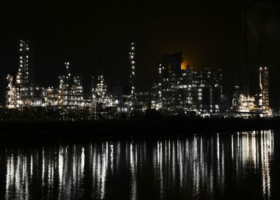 Illuminated buildings against sky at night