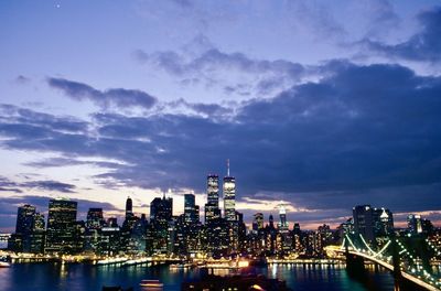 Illuminated buildings in city against sky