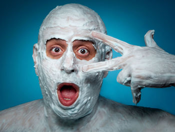 Portrait of white horse against blue background