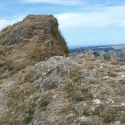 Scenic view of mountains against cloudy sky