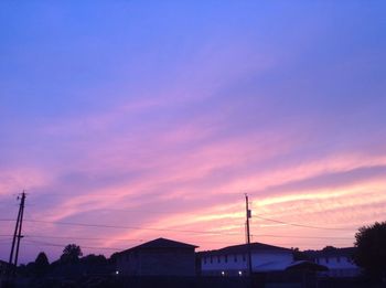 Silhouette buildings against blue sky during sunset