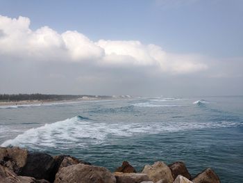 Scenic view of sea against cloudy sky