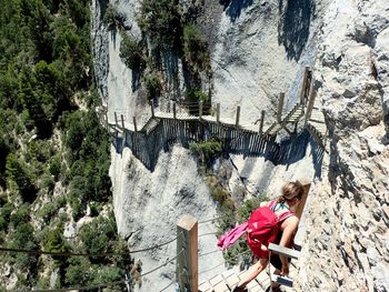 High angle view of woman on staircase over cliff