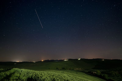 Scenic view of landscape against sky at night