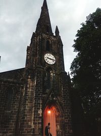 Low angle view of clock tower against building