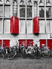 Bicycles parked on sidewalk by building